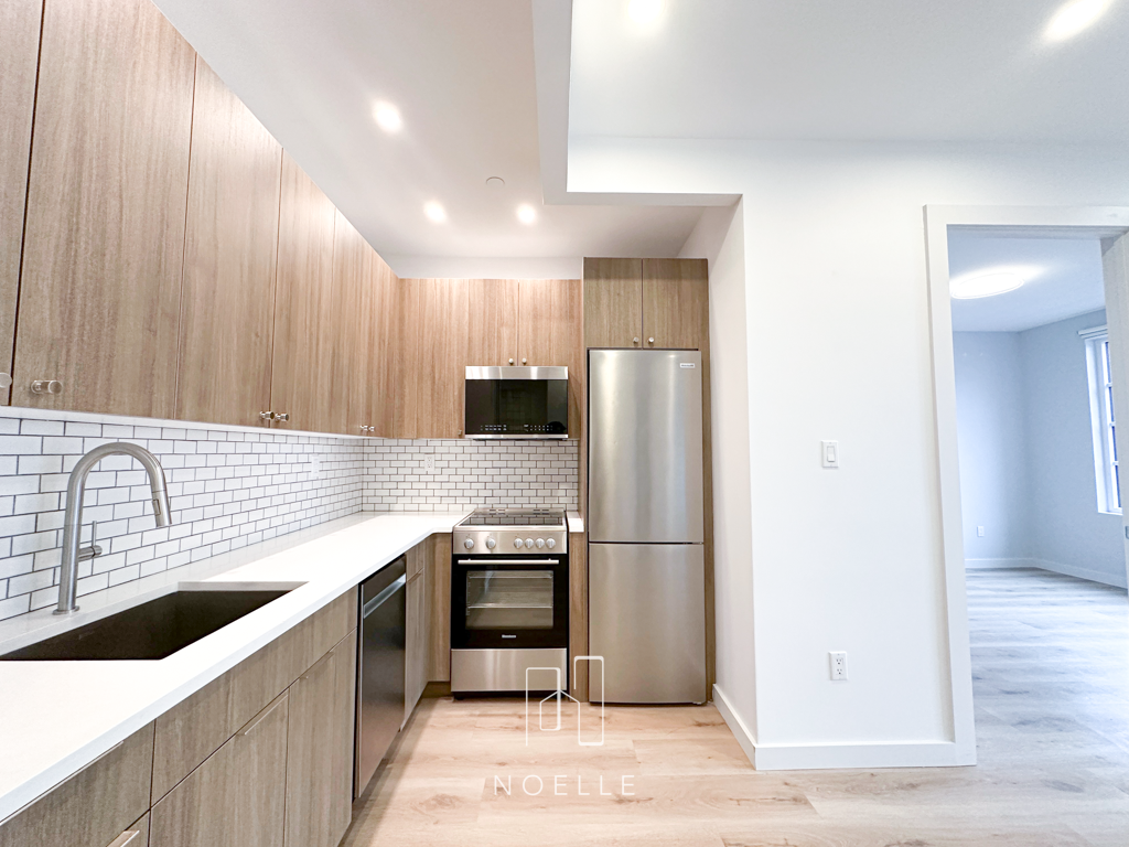 luxury apartment for rent in dumbo, brooklyn. photo shows living space with both bedroom doors to the sides.