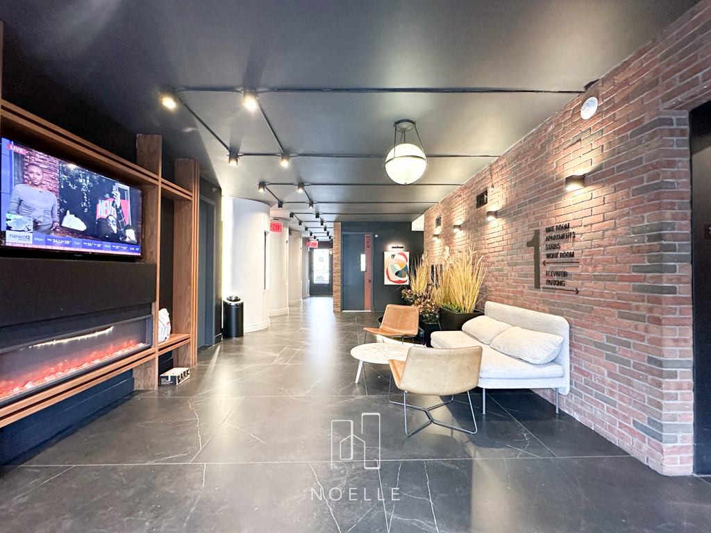 apartment for rent in bed-stuy, brooklyn. photo shows lobby with seating area and tv.